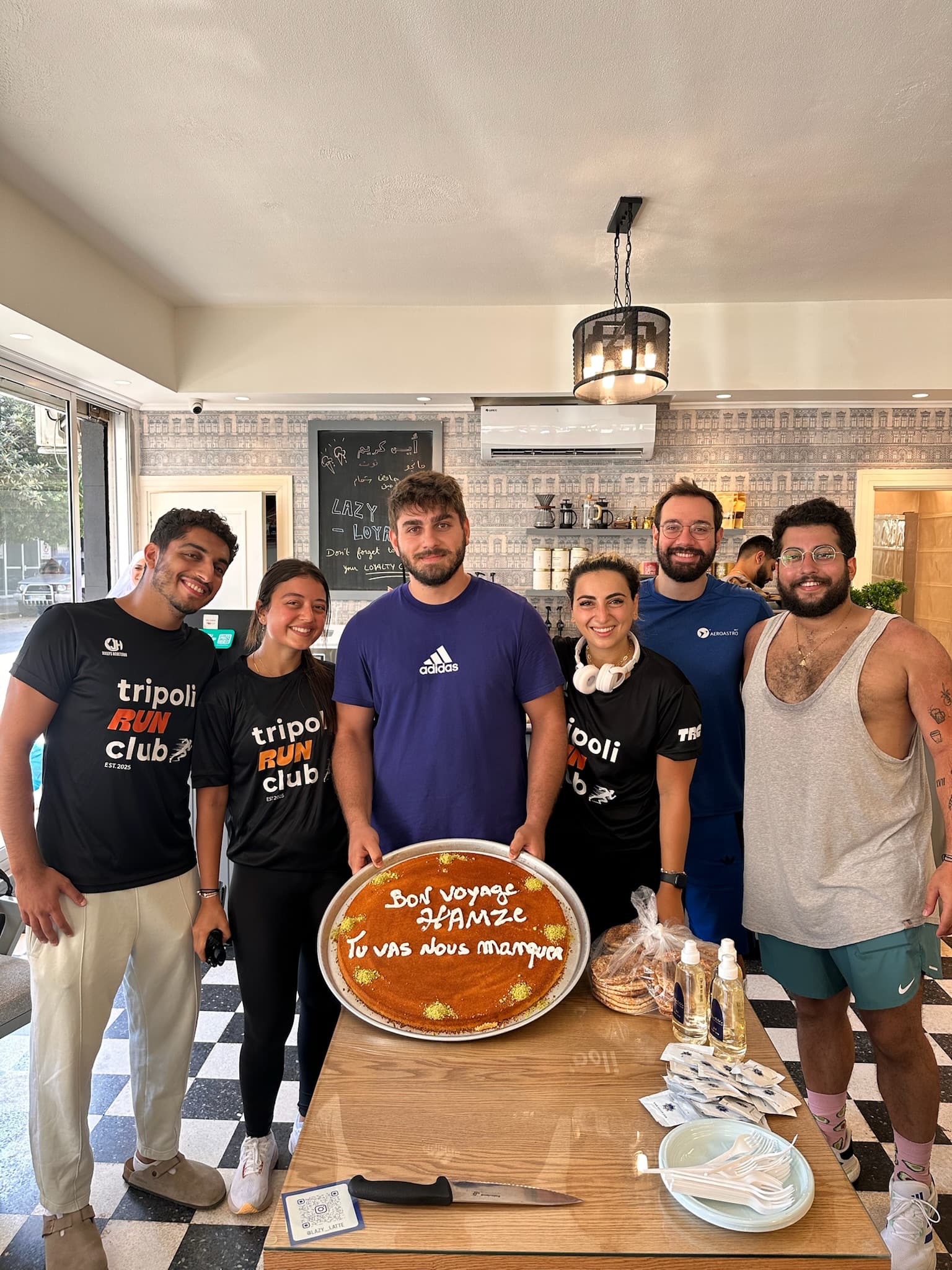 TRC members celebrating with a farewell cake at a cafe